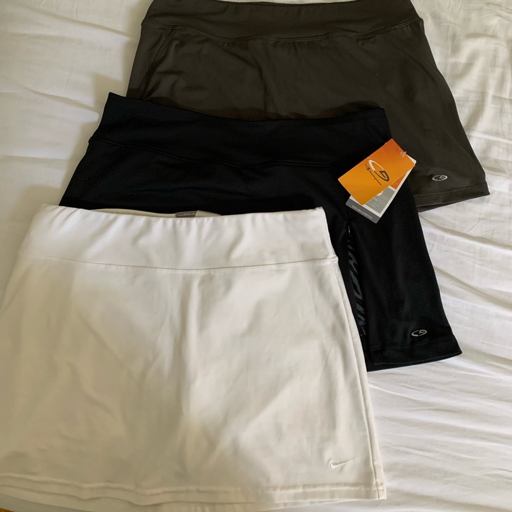 3 medium tennis skirts (1 Nike, 2 champion) in white, grey and black